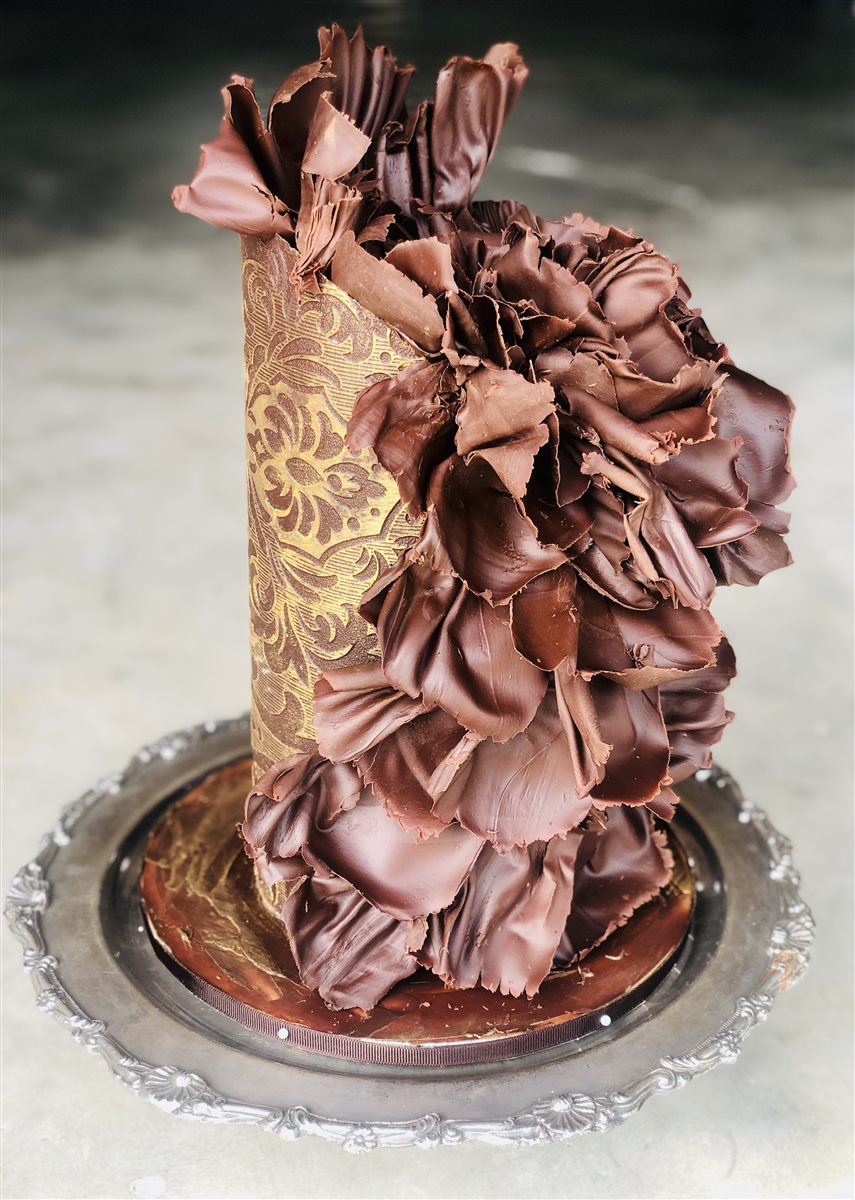 Single-tier gold damask panel cake with sculpted dark chocolate ruffle flower