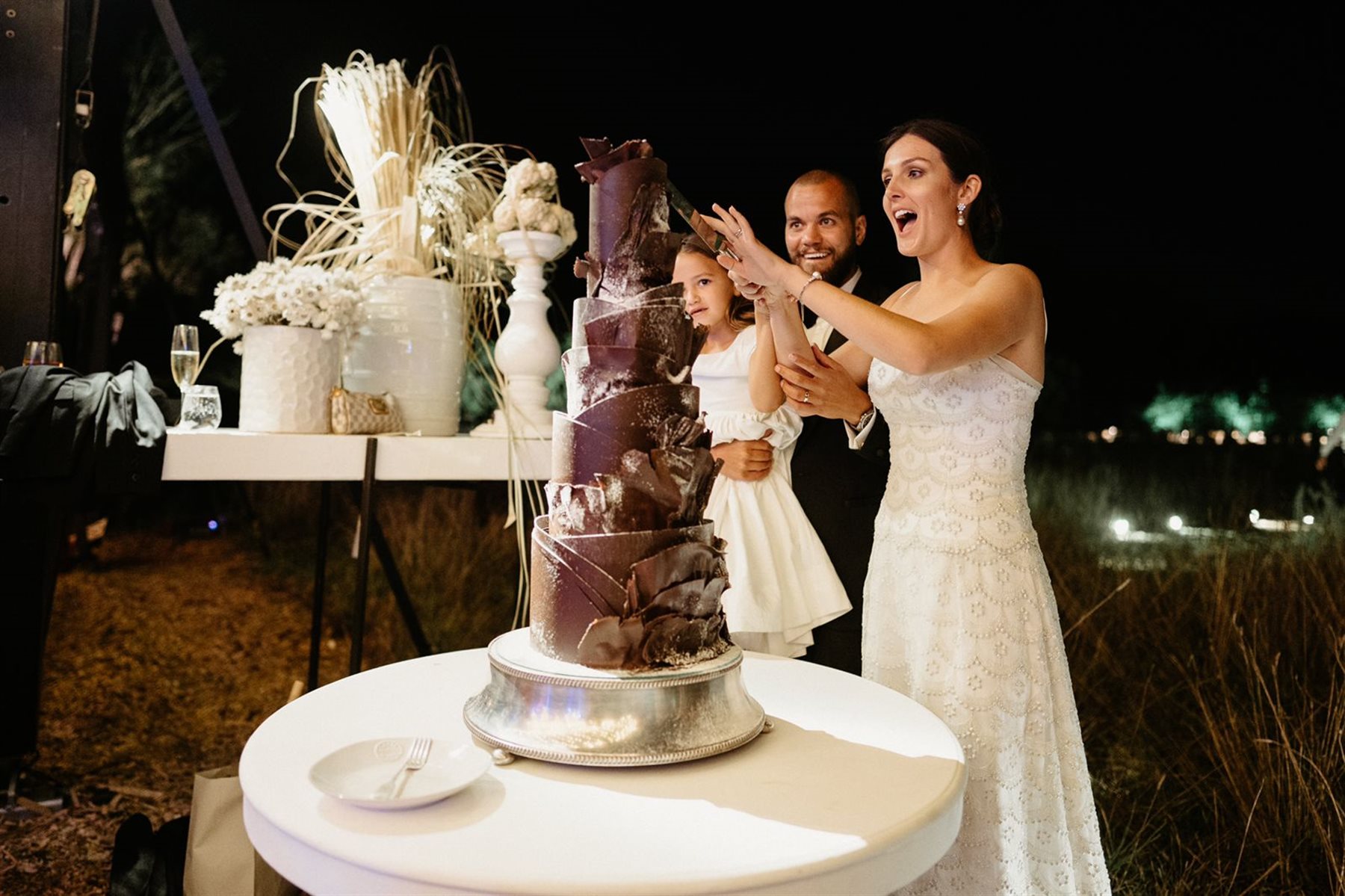 Bride and groom performing a chocolate smash on a couverture cake at a Cape Town wedding