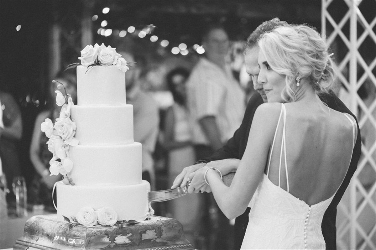 Couple sharing an intimate glance during their couverture chocolate cake-cutting moment