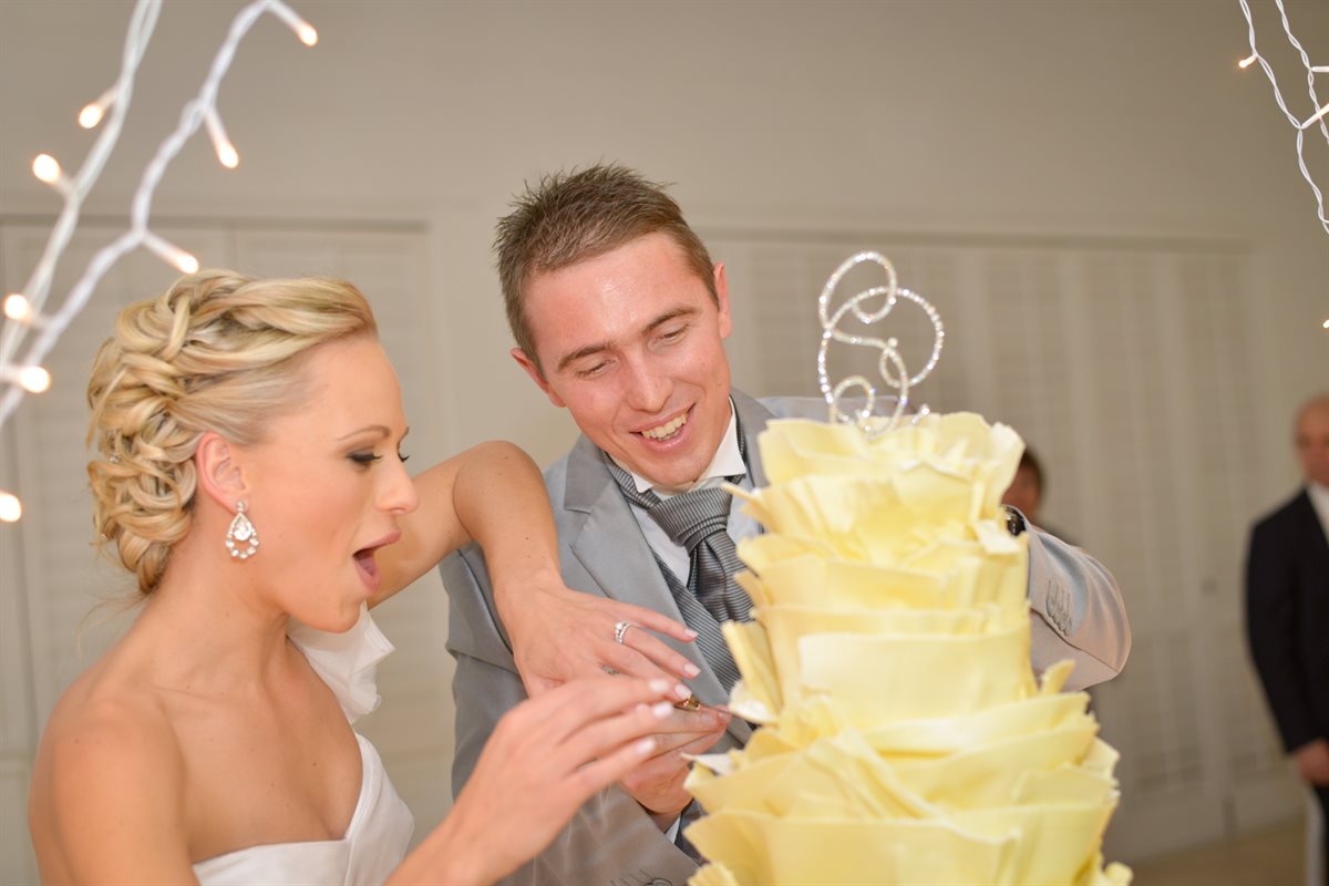 Sone and Chris stealing a taste of their couverture cake before the official cut